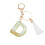 Beige nyckelring med initial och vit tofs 2